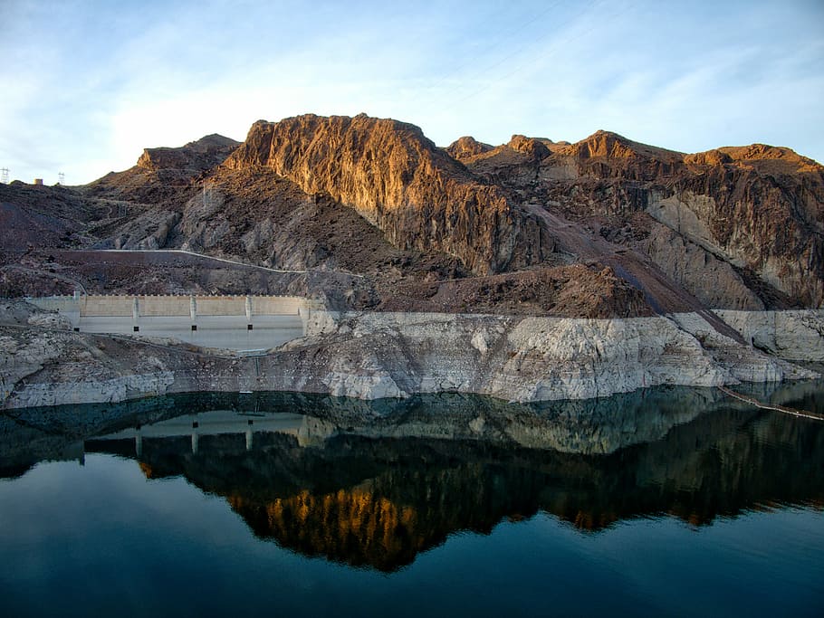 brown mountains beside body of water, dam near body of water and mountain at daytime HD wallpaper