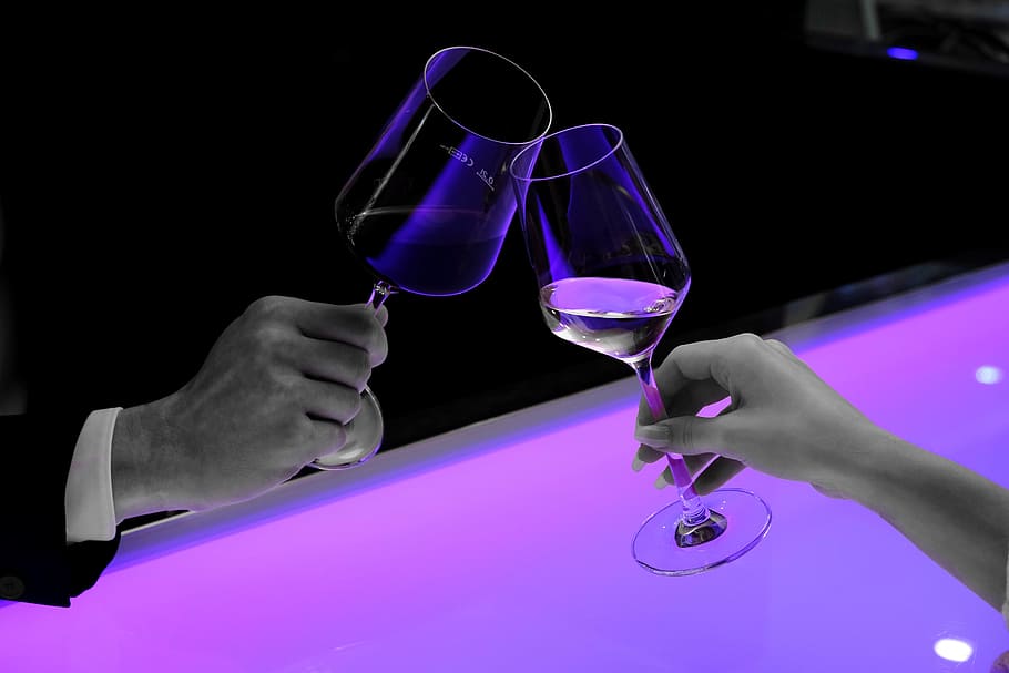 two person both holding clear wine glasses, abut, prost, hands