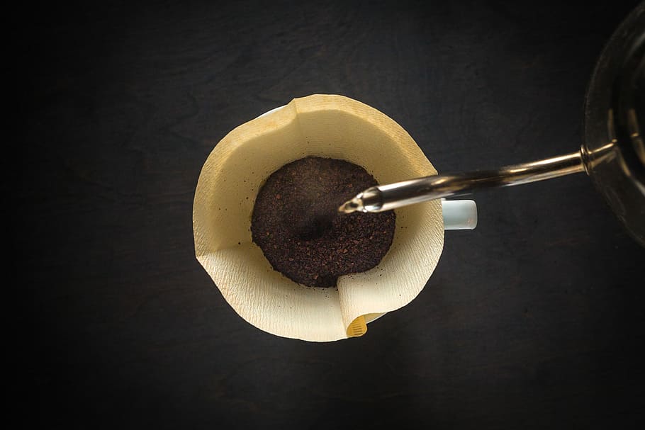 water pouring on brown mug, top-view photography of coffee powder in beige cup HD wallpaper