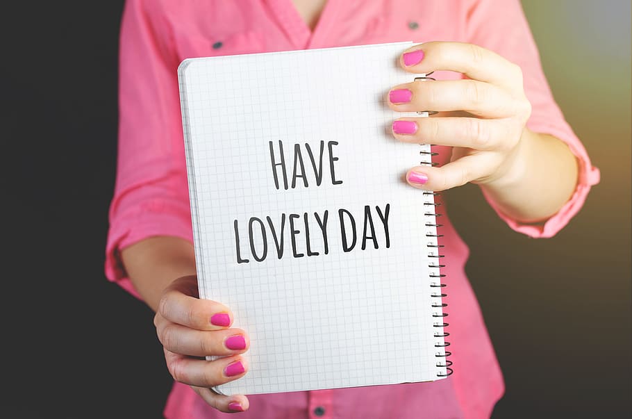 Woman Wearing Pink Dress Holding Graphing Notebook With Have a Lovely Day Sign, HD wallpaper