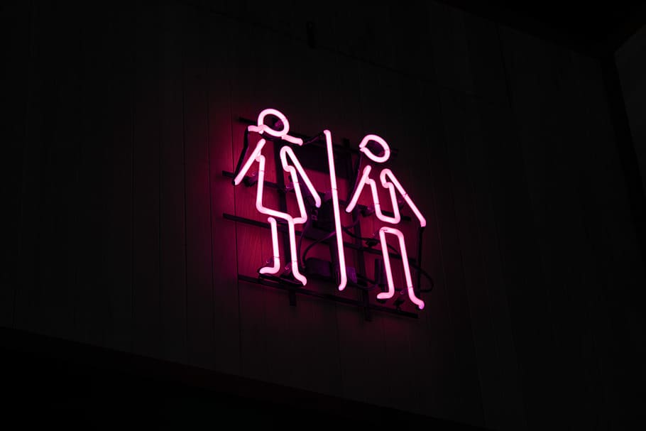 man and woman neon signage at dark area, man and woman neon signage