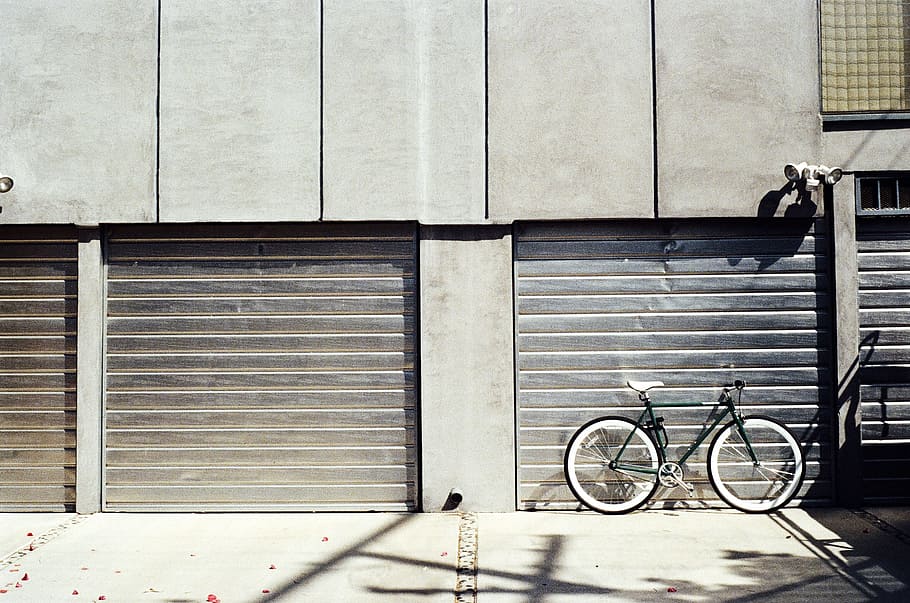 black bicycle parked in front of garage door, garages, shut, shutters, HD wallpaper