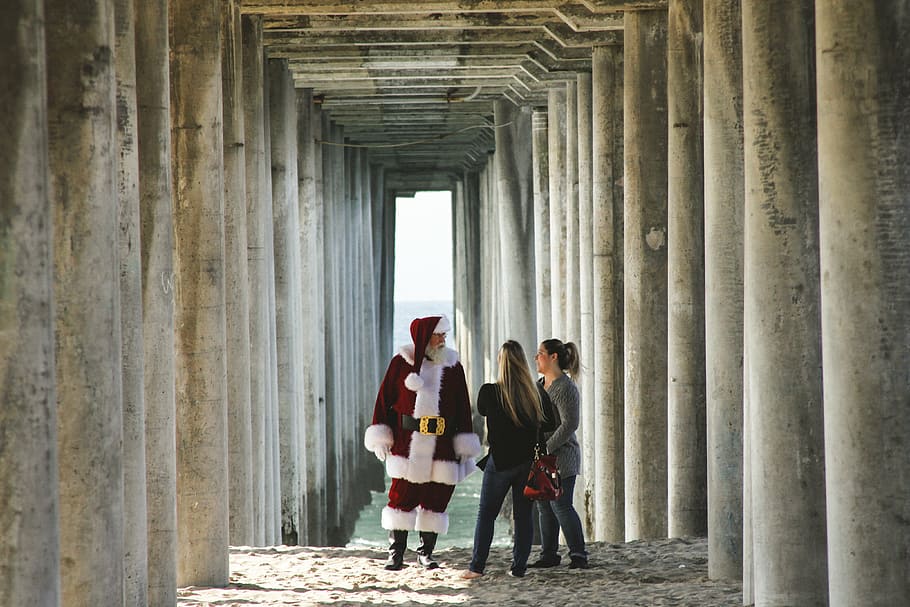 two woman standing in front of Santa Claus during daytime, wearing HD wallpaper