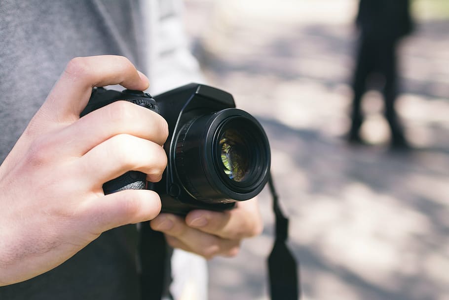 person holding black DSLR camera during daytime, blur, blurry HD wallpaper
