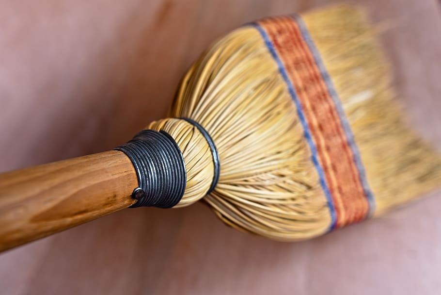 close-up photo of brown soft broom, rice straw broom, broomstick