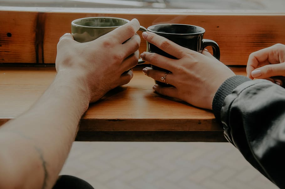 person holding mugs photo, two person holding mug on tabletop HD wallpaper