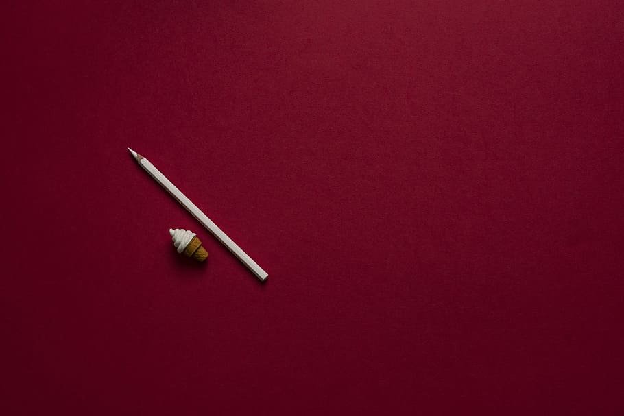 white pointed pencil, white pencil beside ice cream cone eraser on red platform HD wallpaper