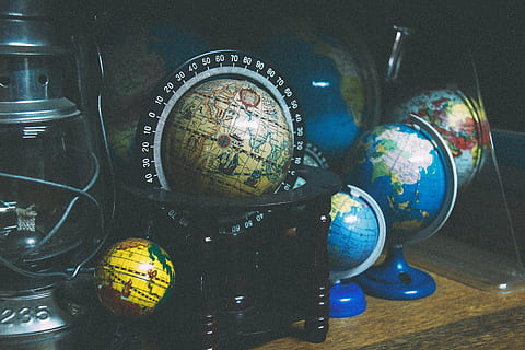assorted globes on wooden table, black, floor, world, travel HD wallpaper
