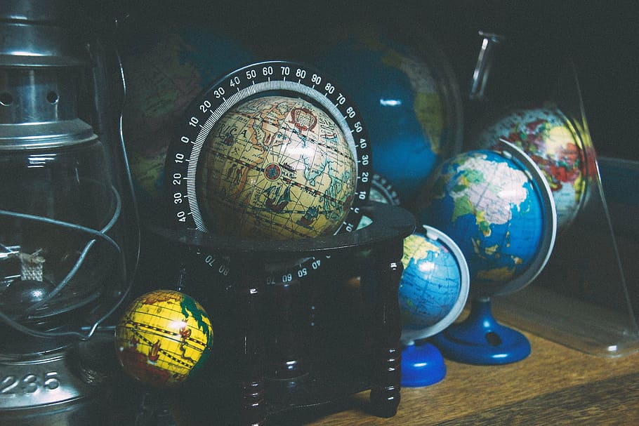 assorted globes on wooden table, black, floor, world, travel HD wallpaper