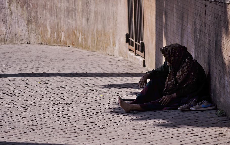 person sitting on floor while leaning on wall during daytime HD wallpaper