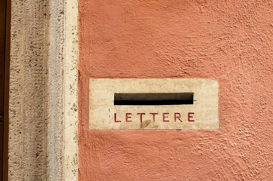 orange and white concrete surface, white lettere hole, letter box