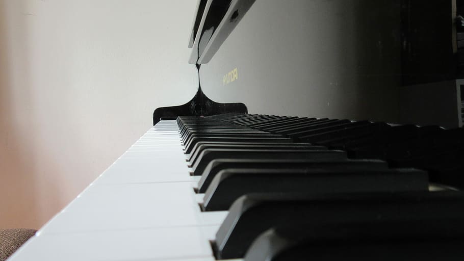 shallow focus photography of black and white upright piano, keys