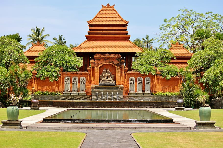 orange temple surrounded with trees painting, kuta, bali, indonesia