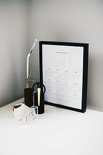 calendar with black frame on table, white calendar on table beside lamp HD wallpaper
