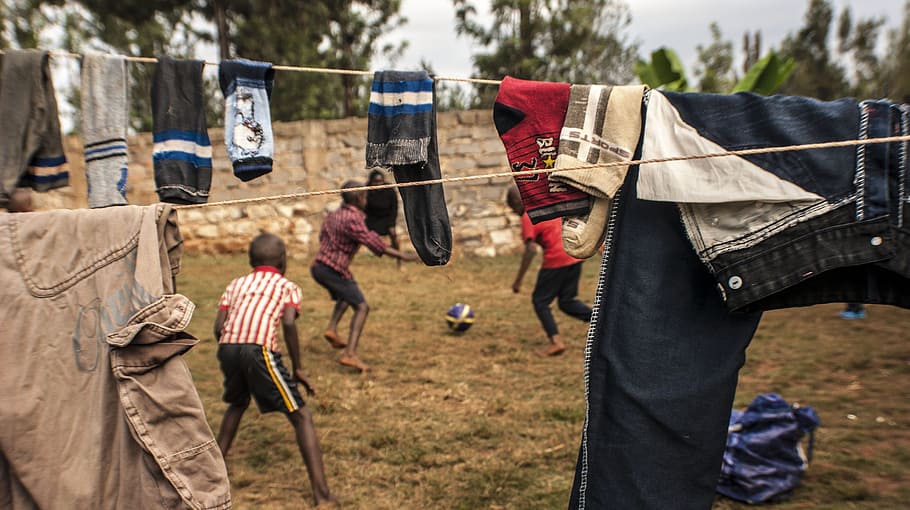 Football in Kenya, group of boys playing soccer outdoor, children