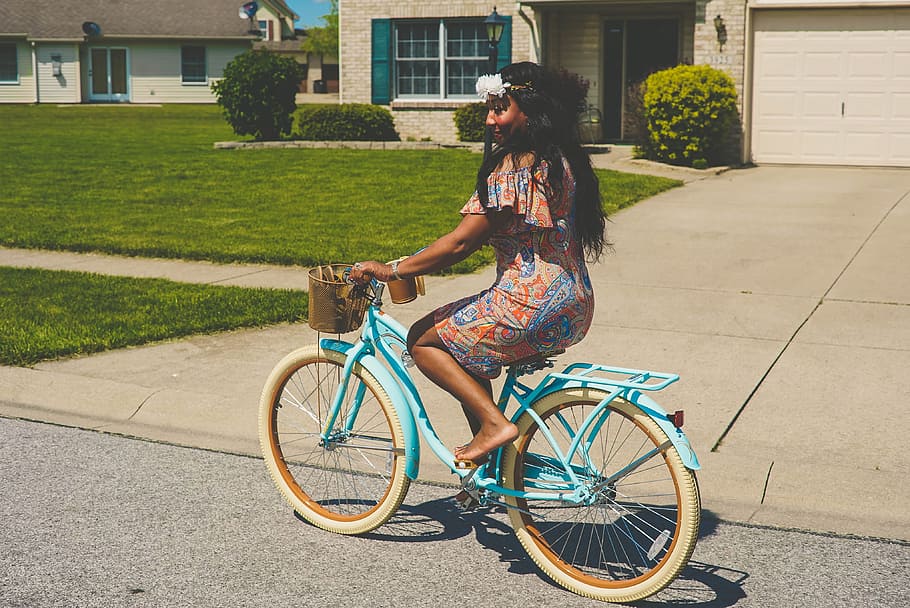 woman in brown and blue dress riding blue bicycle, woman' riding bicycle on street during daytime HD wallpaper