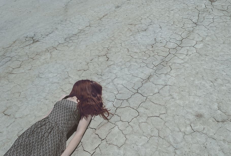 woman lying down on floor, people, road, crack, hair, dress, nature
