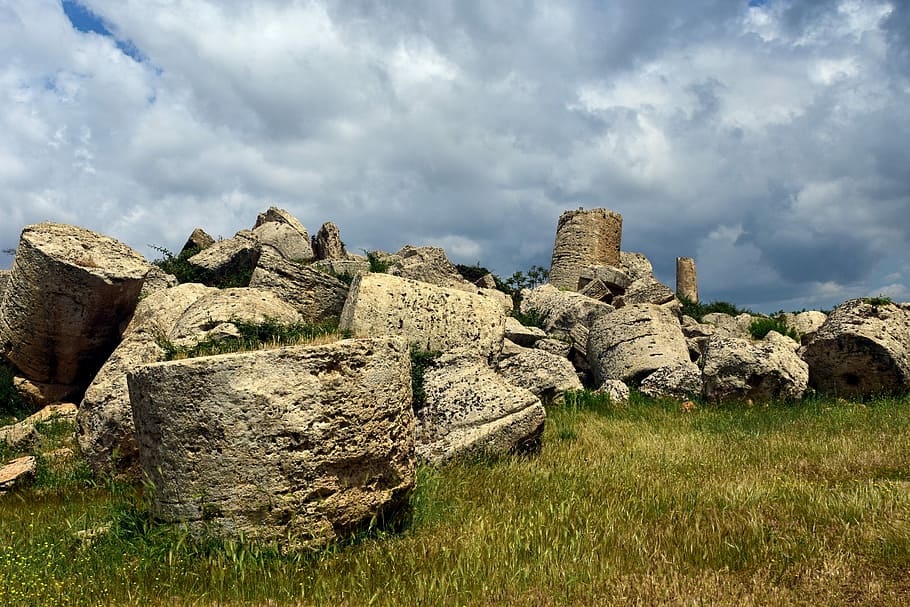 piles of brown boulders on green grass under cloudy sky, temple HD wallpaper