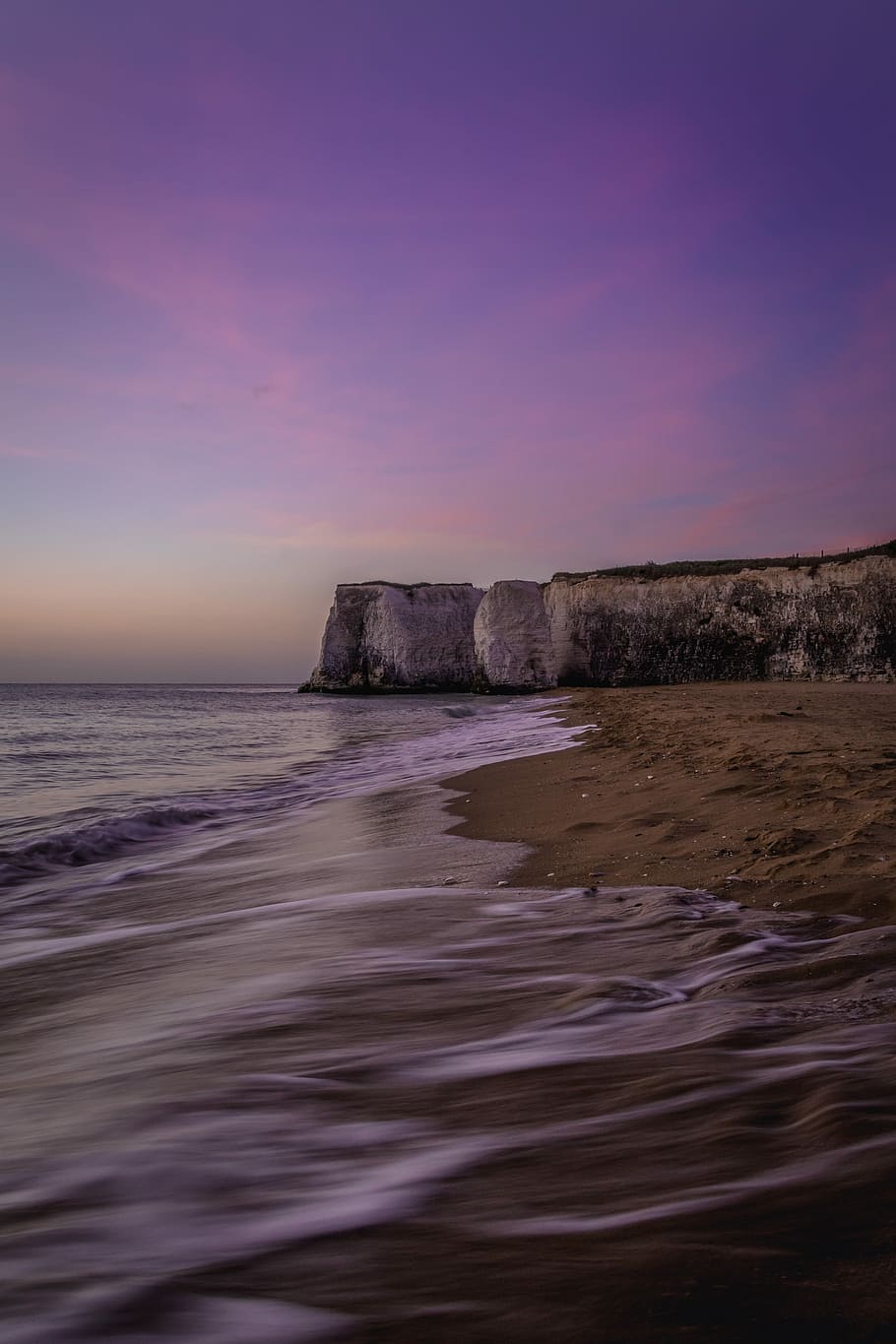 time lapse photography of seashore waves, white rock formation near brown shore and body of water HD wallpaper