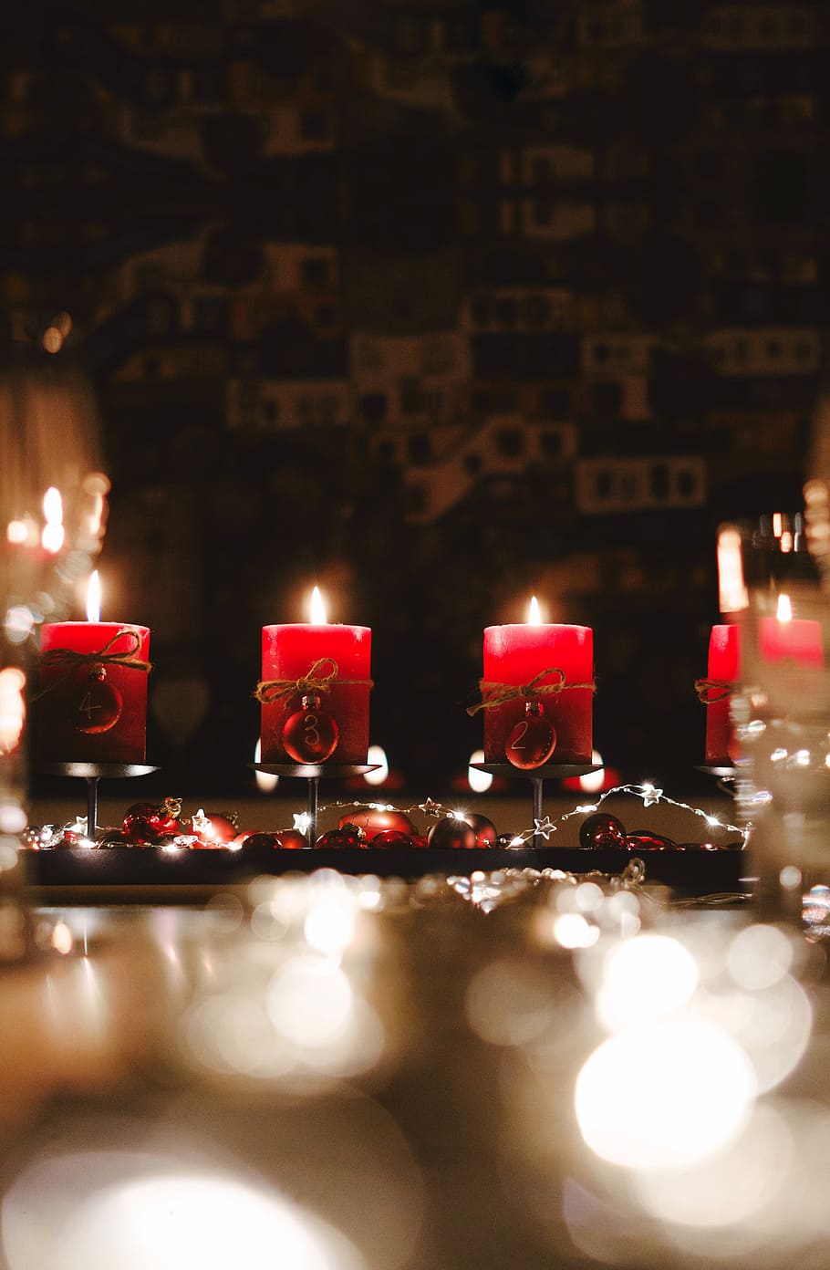 four lighted candles, depth photography of red candles in rack HD wallpaper