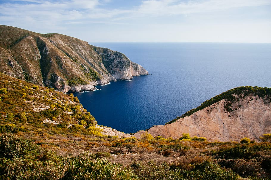 landscape of mountain near ocean, top angle photography of island surrounded by sea water at daytime HD wallpaper
