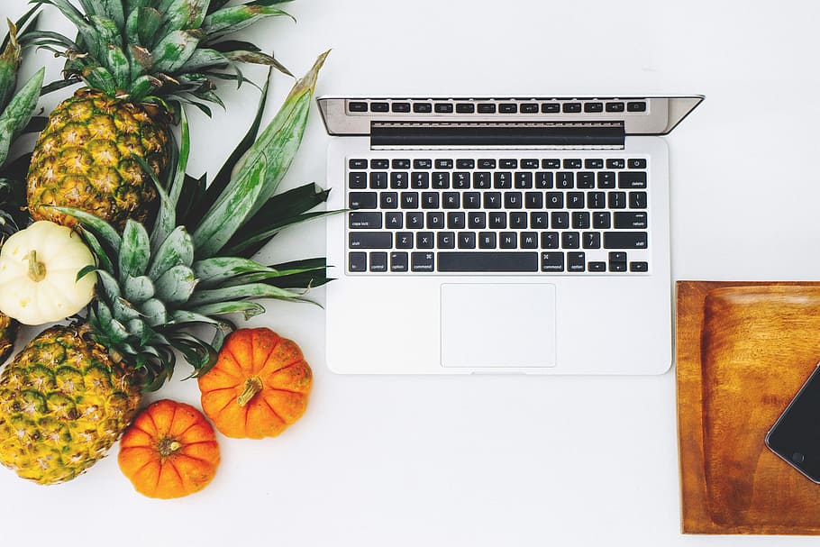 MacBook Pro and assorted fruits flat lay photography, MacBook beside pineapples and squash HD wallpaper