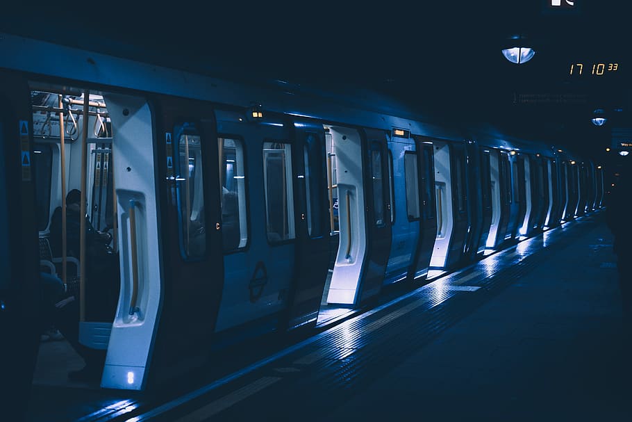 lighted open door train, person sitting inside the train during nighttime, HD wallpaper