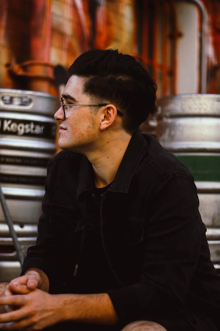 selective focus photography of man wearing black jacket and eyeglasses HD wallpaper