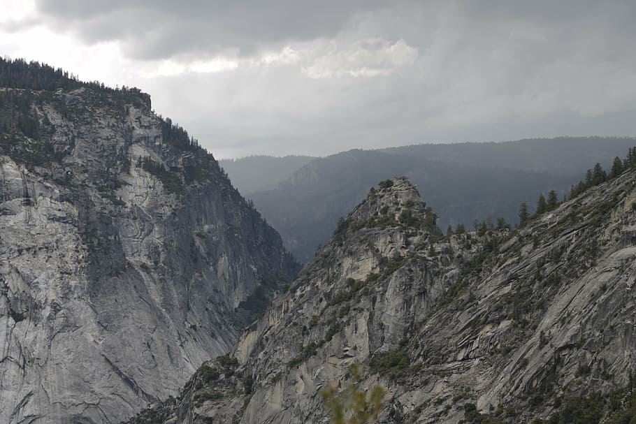 gray rock mountains under gray clouded sky at daytime, yosemite
