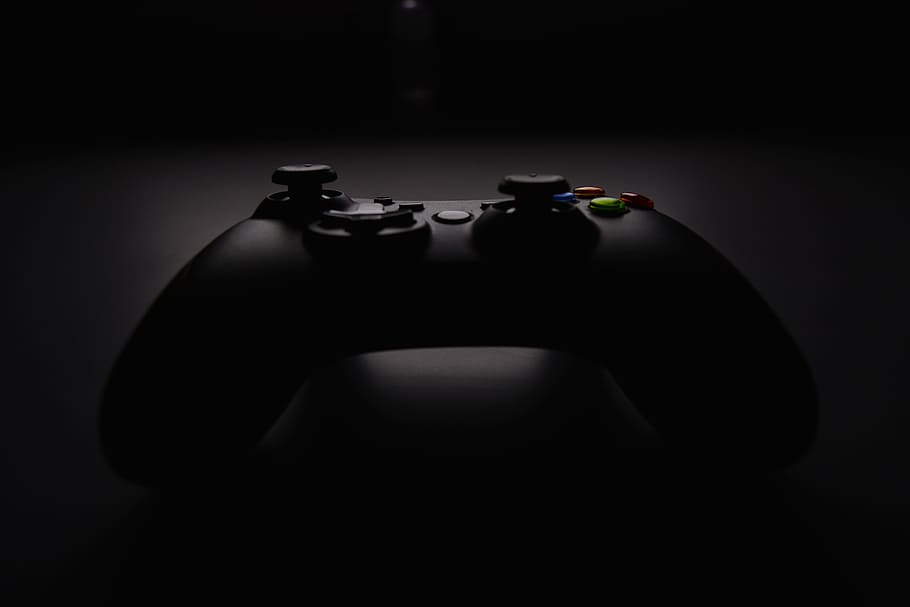 shallow focus photography of black Xbox controller, black wireless console controller