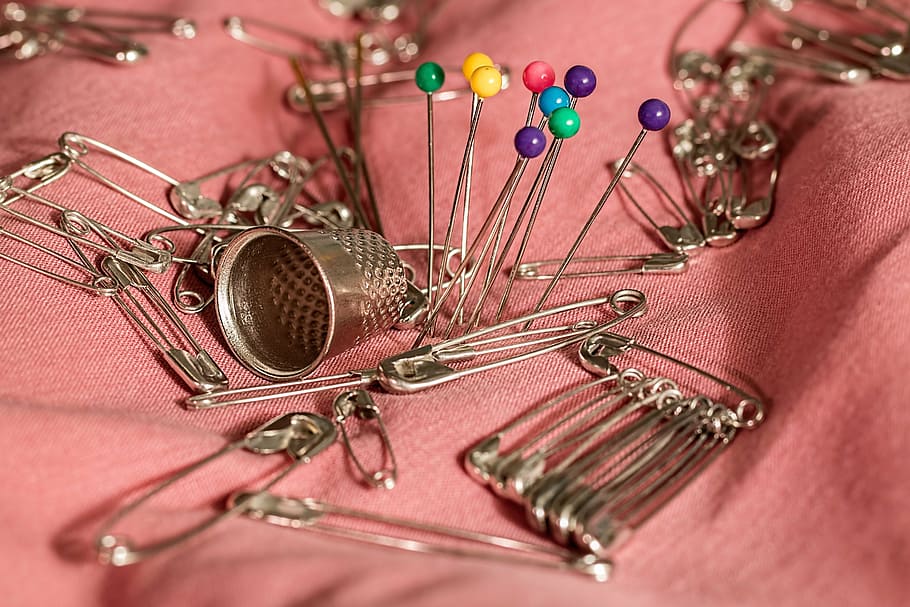 silver safety pins, sewing, thimble, needle, mending, repair