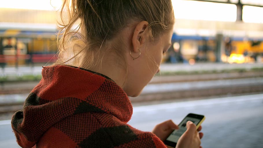 woman in red and black hoodie using mobile phone on road, one Person HD wallpaper
