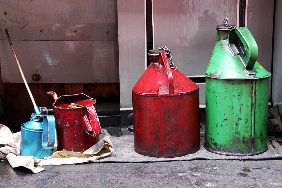 four assorted-color gas cans near gray wall, Oil, Container, Industry, HD wallpaper