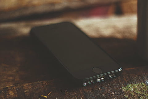 space gray iPhone 6 with black screen on brown wooden surface HD wallpaper