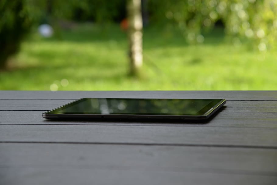 black tablet computer with black screen on table, technology HD wallpaper