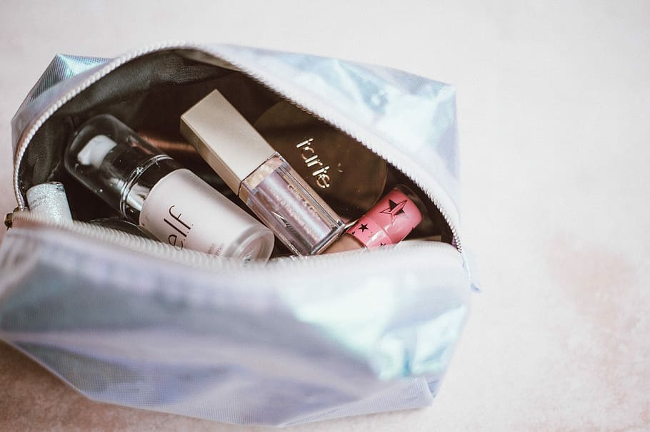 Make up bag, assorted-brand cosmetic bottles, makeup, purse, finance HD wallpaper