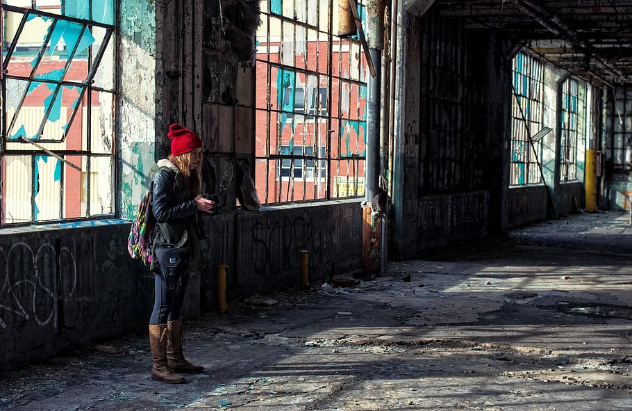woman wearing red knit cap inside abandoned building near window HD wallpaper