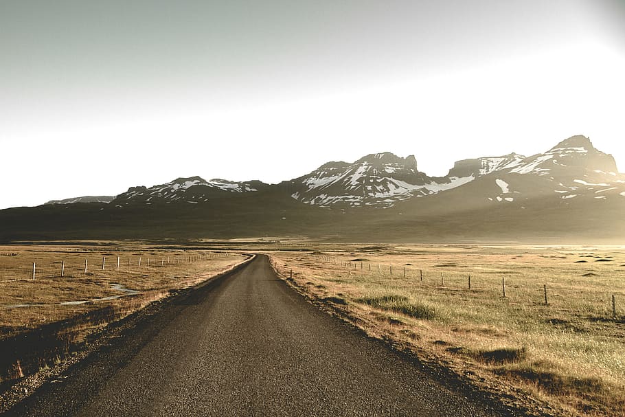 dirt road between steppe, road between field near glacier mountains during day HD wallpaper