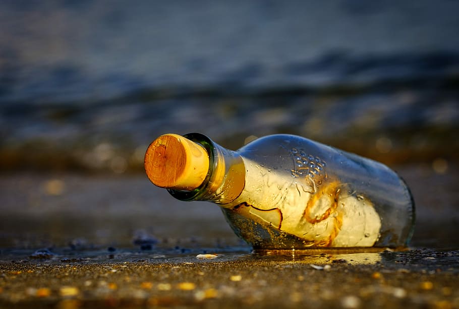 clear glass bottle with cork, message in a bottle, sea, wreck