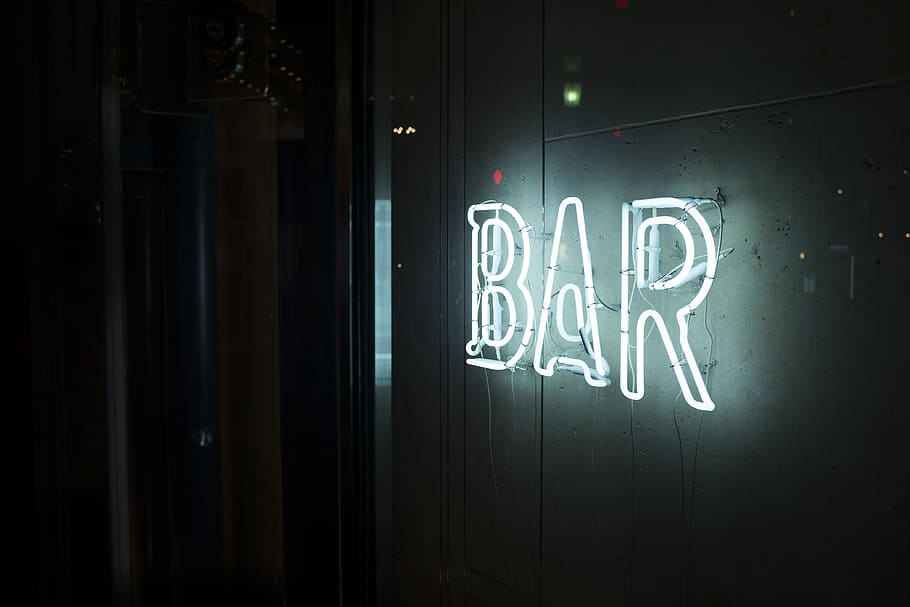 photo of turn-on white bar neon sign, lighted bar neon signage