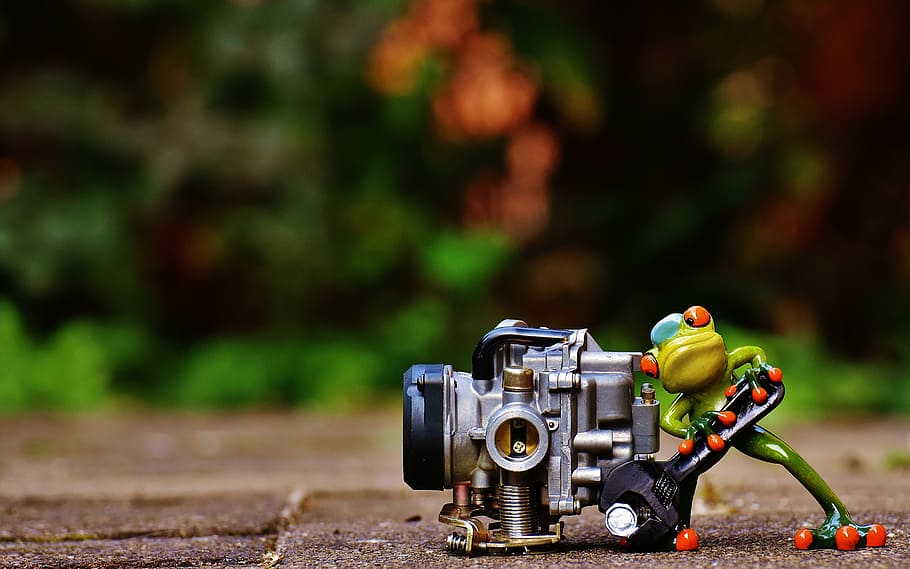 green frog pushing gray motorcycle carburetor, mechanic, screwdrivers