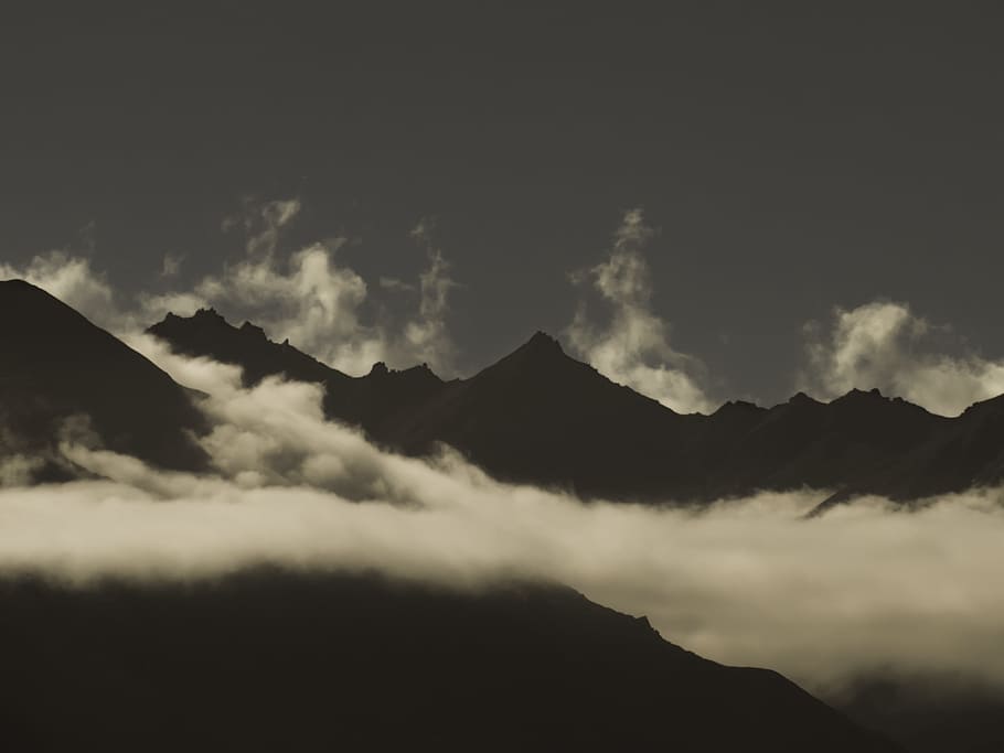 mountains surrounded by sea of clouds during daytime, shallow focus photography of white sky HD wallpaper