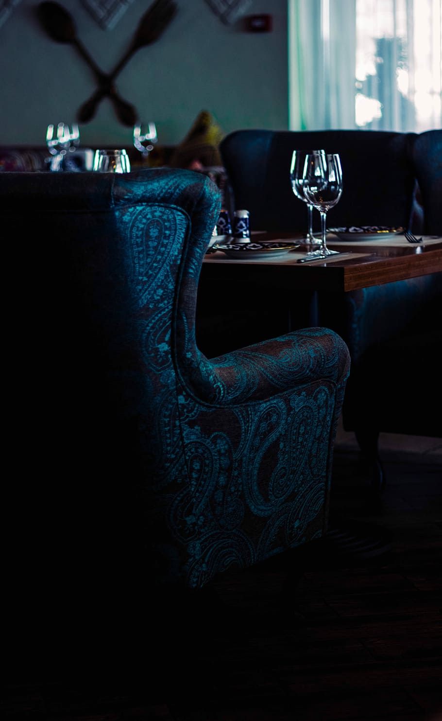 gray and brown paisley chair near brown table, blue and brown paisley print sofa in front of wooden table with two clear wine glasses inside room HD wallpaper
