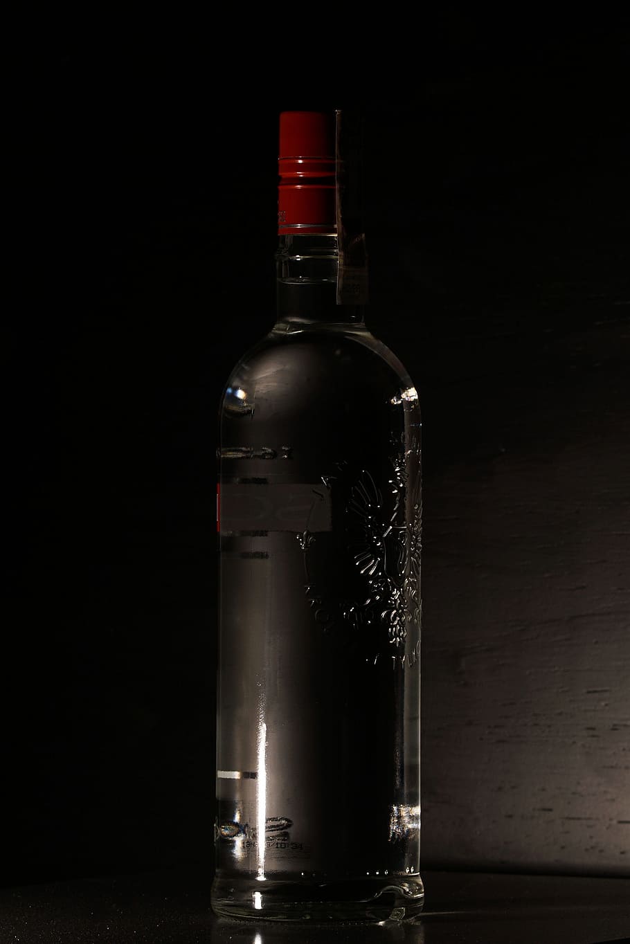 A bottle of belvedere vodka on a black background photo – Free Somewhere  Image on Unsplash