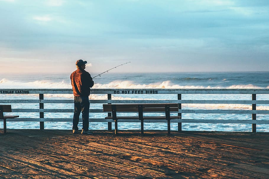 man fishing on body of water, bay, near, bench, day, time, sea HD wallpaper