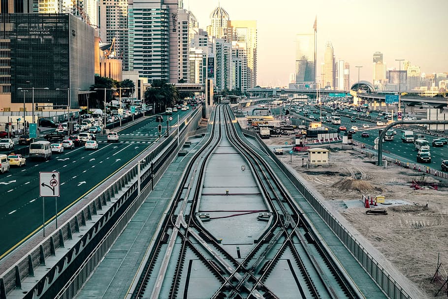 bird's-eye of view of train rail in the middle of city, gray metal railways in between road HD wallpaper