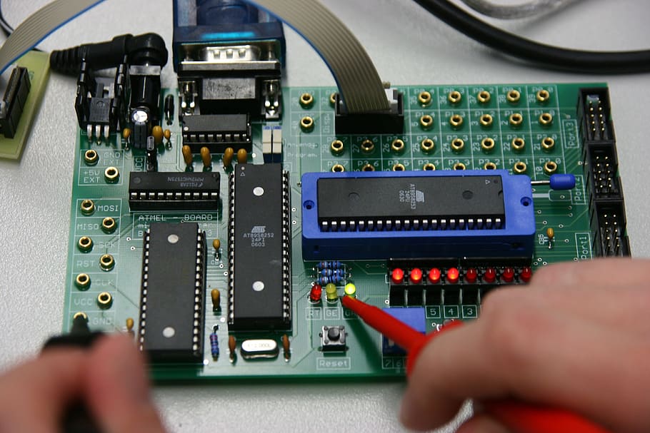 person holding soldering iron, board, electronics, computer, training