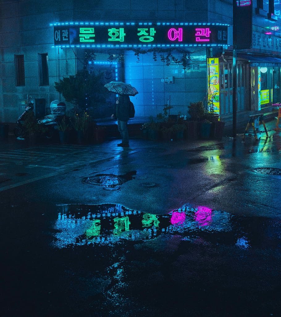 Midnight Rain, person standing holding opened umbrella, neon