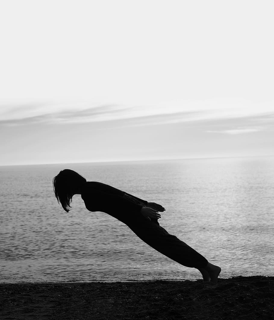 person doing gravity lean on the shore, silhouette of person on seashore HD wallpaper