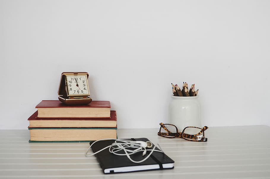 book and sunglasses on table, books placed on table beside eyeglasses and pencil case HD wallpaper